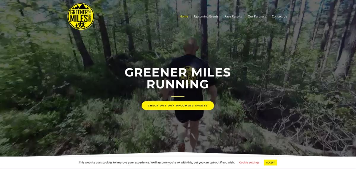 Greener Miles Running website homepage showing a trail runner in woodland